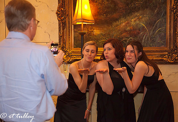 photo ops;bridesmaids blowing kisses at man with camera phone